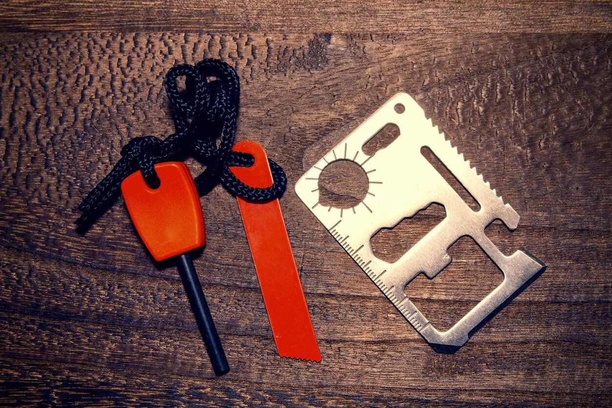 Survival card factory: ferro rod and survival card on wooden table.